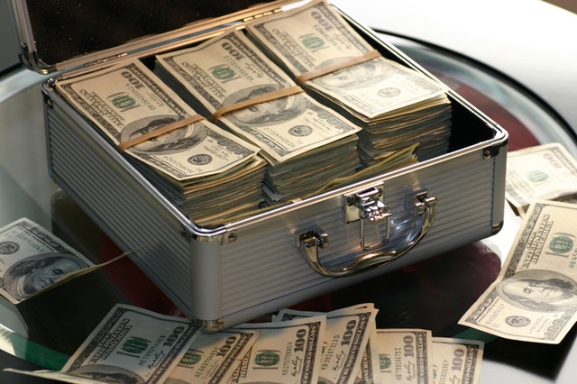 stacks of money in a metal money box