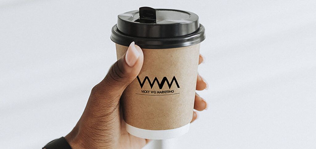 Hand holding a coffee cup mockup