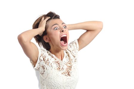 Scared crazy woman crying with hands on head