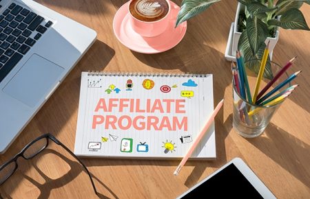 AFFILIATE PROGRAM open book on table and coffee Business